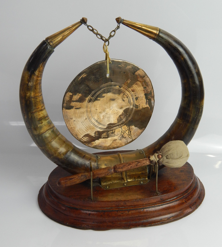 Appraisal: A brass table gong mounted on a pair of bull