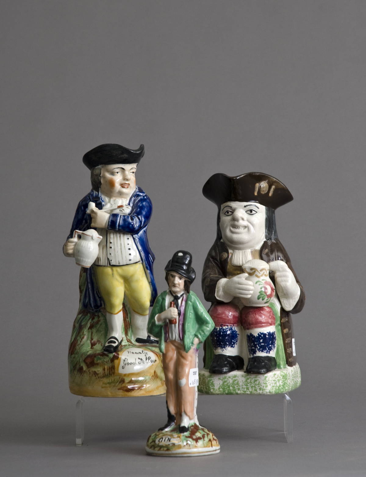 Appraisal: TWO STAFFORDSHIRE TOBY PITCHERS AND A 'GIN AND WATER' FIGURAL