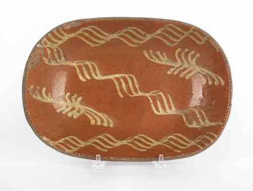 Appraisal: Pennsylvania redware loaf dish th c with yellow slip decoration