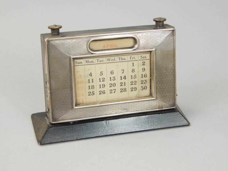 Appraisal: An Elizabeth II silver mounted desk calendar on an ebonised