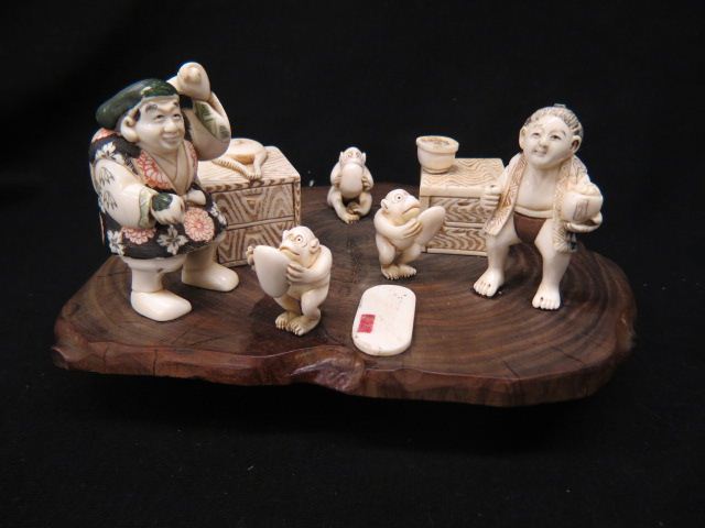 Appraisal: Chinese Carved Ivory Wood Grouping monkeys at feeding time with