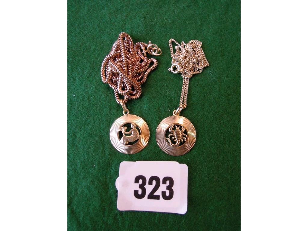 Appraisal: Two zodiac pendants on chains stamped gms