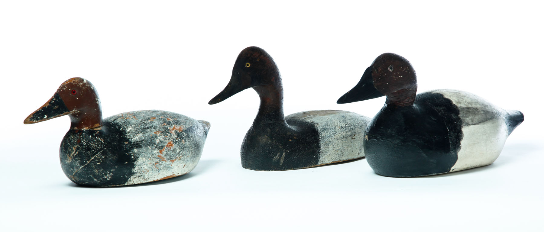 Appraisal: THREE DECOYS American mid th century Canvasbacks with original paint