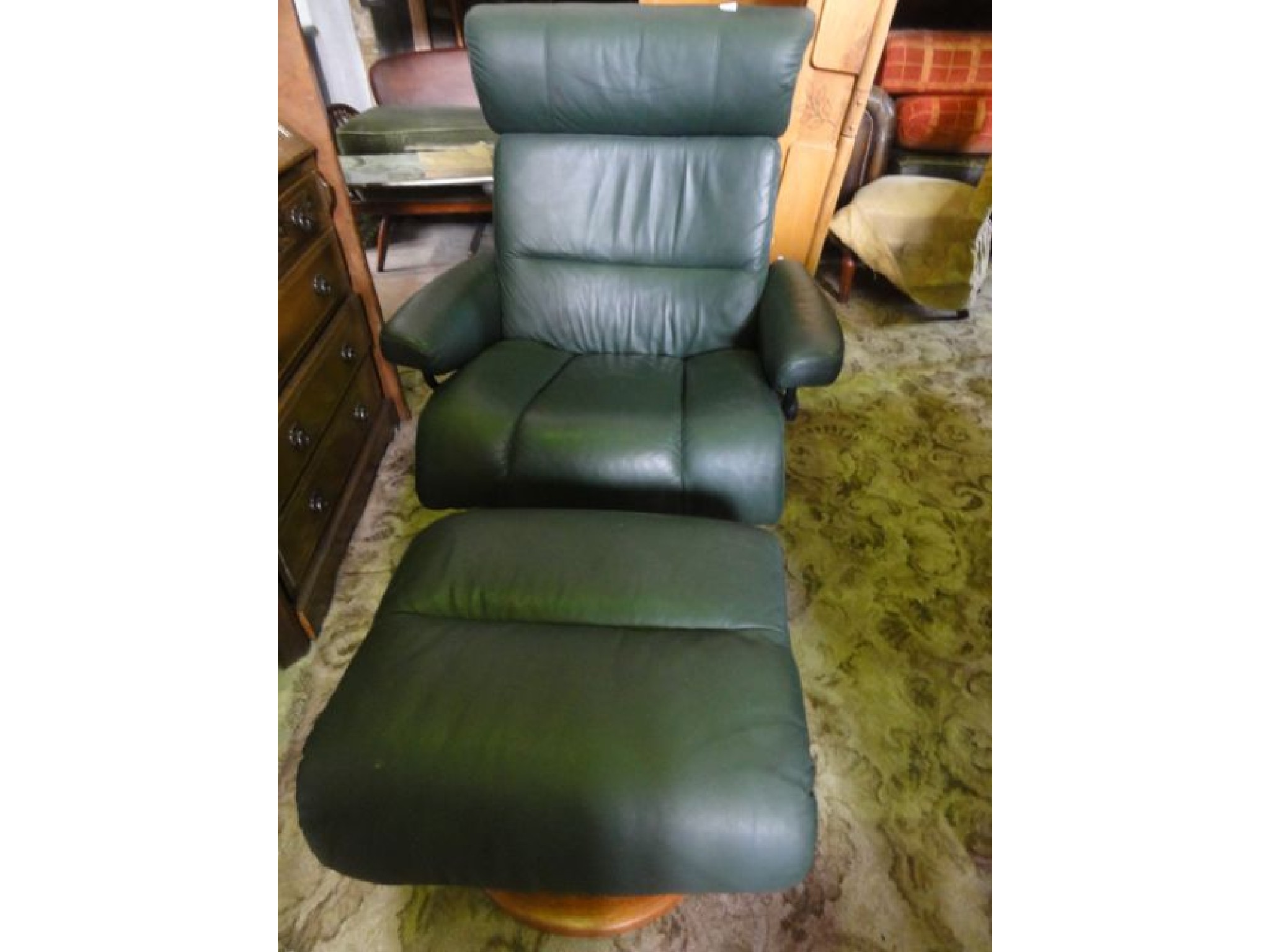 Appraisal: A contemporary Ekornes Stressless revolving adjustable reclining armchair with green