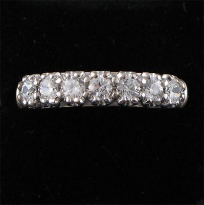 Appraisal: A diamond half hoop ring the seven brilliants mounted in