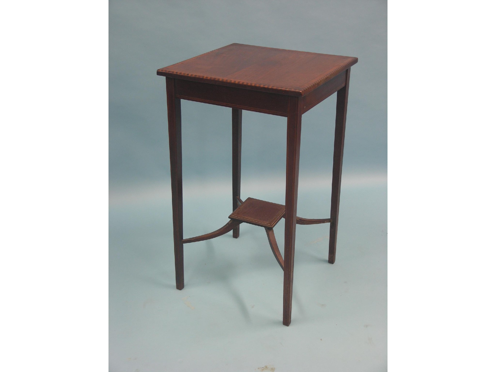 Appraisal: An Edwardian mahogany occasional table square top with satinwood cross-banding