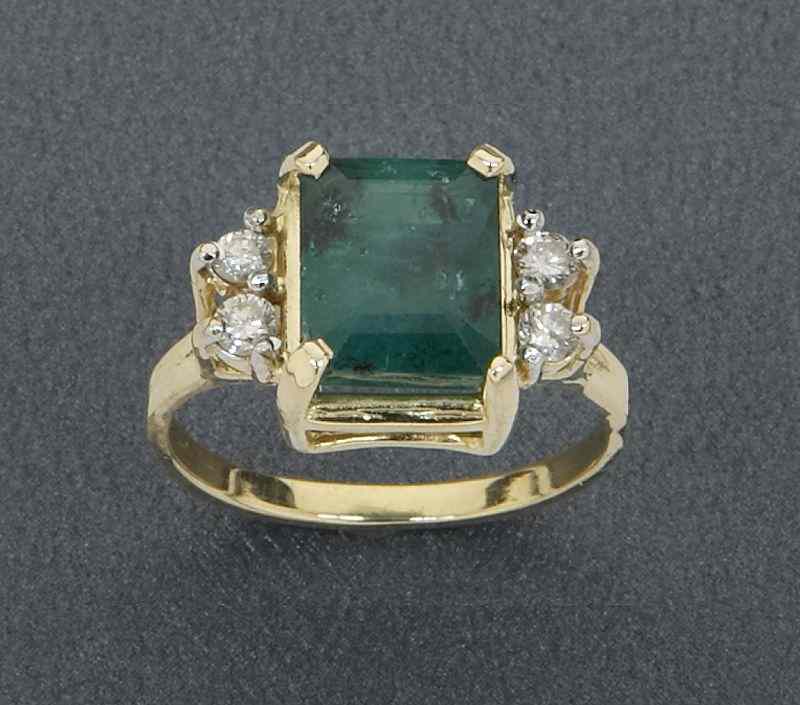 Appraisal: K gold emerald and diamond dinner ring having an emerald