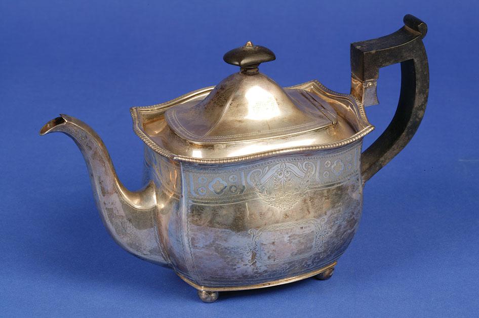 Appraisal: A GEORGE III IRISH TEAPOT of shaped rectangular form with