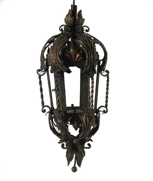 Appraisal: A pair of wrought iron and tole wall lanterns on