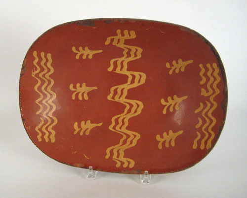 Appraisal: Redware loaf dish th c with a yellow slip decoration