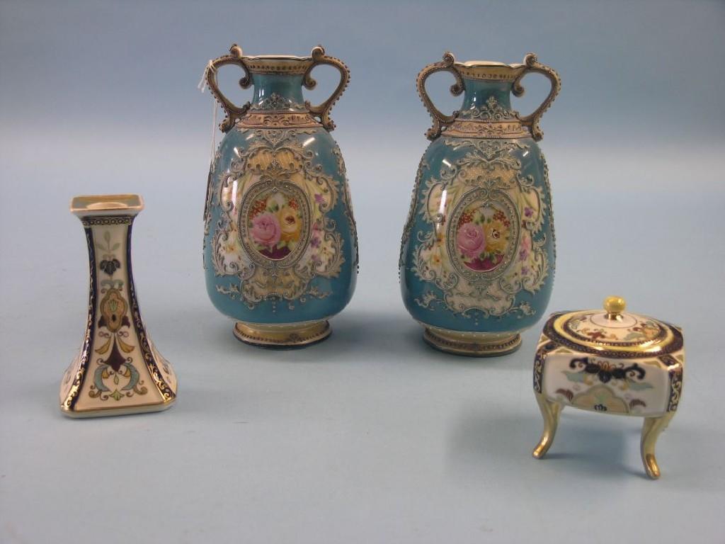 Appraisal: A pair of Noritake porcelain vases floral designs against a