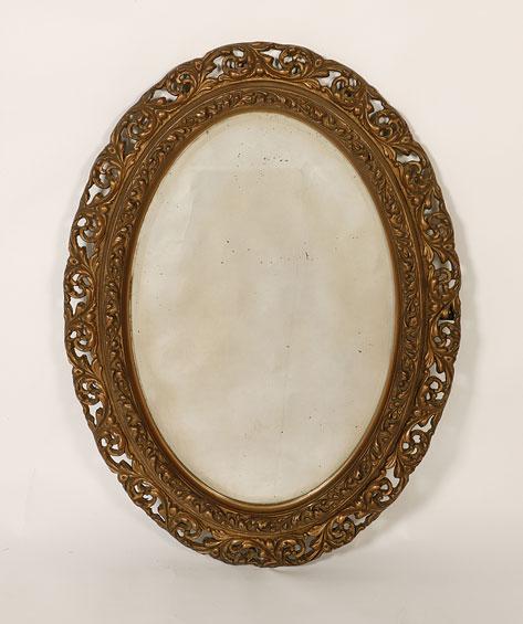 Appraisal: A BAROQUE STYLE GILT FRAMED WALL MIRROR the oval bevel