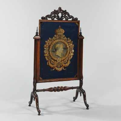 Appraisal: A Caved Mahogany Fire Screen Gracefully carved mahogany fire screen