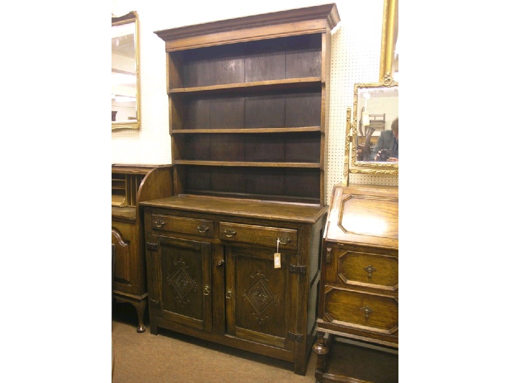 Appraisal: An early th century solid dark oak Welsh dresser plate