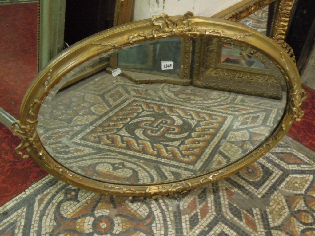 Appraisal: A Victorian gilt framed wall mirror of oval form with