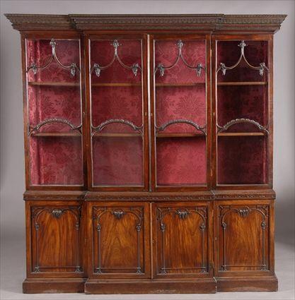 Appraisal: CHIPPENDALE-STYLE CARVED MAHOGANY BREAKFRONT BOOKCASE The upper part with petal