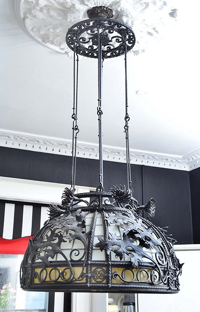 Appraisal: A LARGE WROUGHT IRON CHANDELIER with opaque shade having leaf