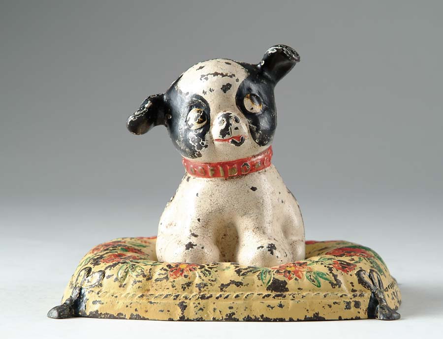 Appraisal: CAST IRON DOG STILL BANK Puppy dog sits on hand