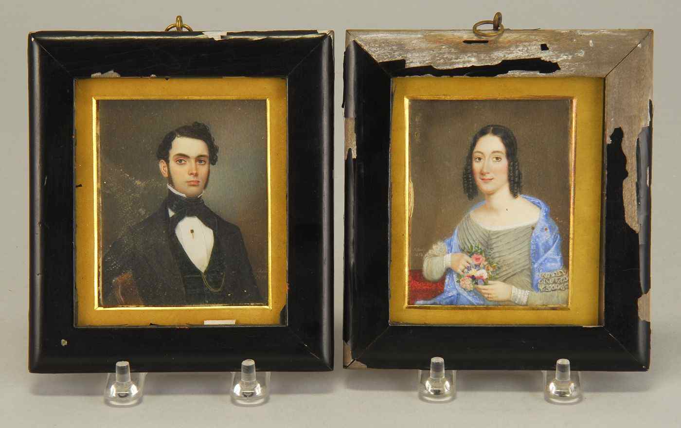 Appraisal: PAIR OF FRAMED MINIATURE PORTRAITS ON IVORYMid- th CenturySigned and