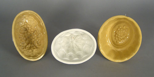 Appraisal: Two yelloware molds together with a white ironstone mold largest