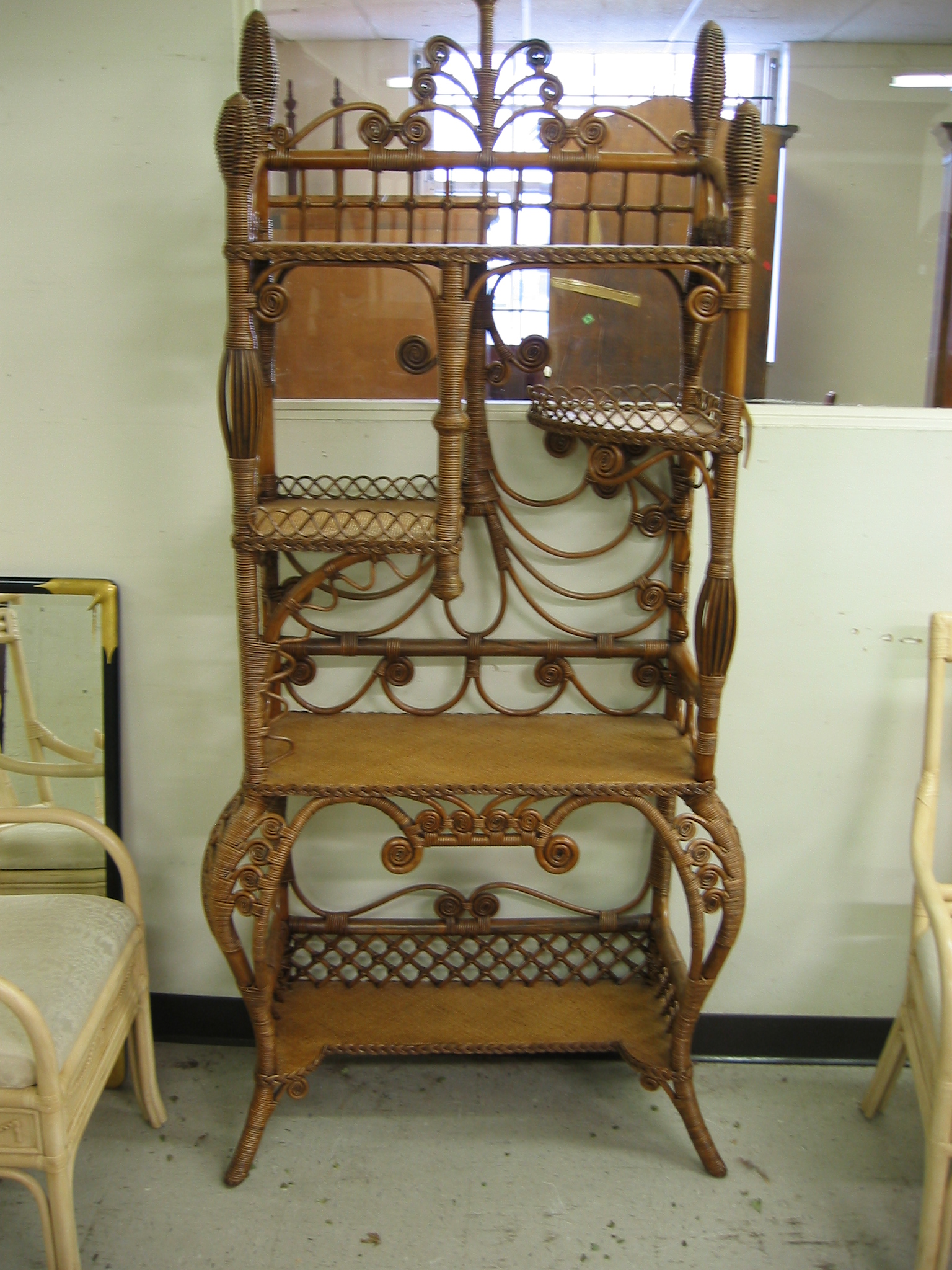 Appraisal: WICKER AND RATTAN DISPLAY STAND having five levels of open