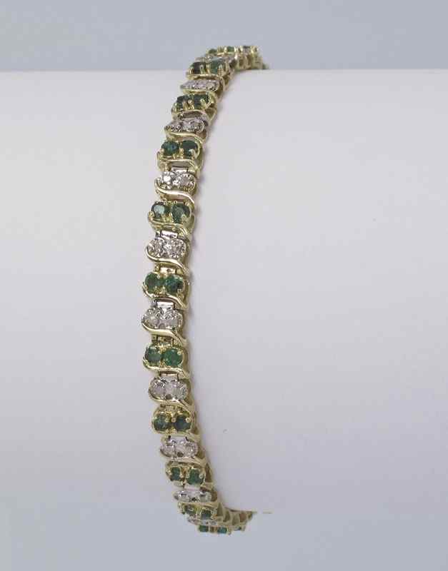 Appraisal: EMERALD AND DIAMOND BRACELET K yellow gold line bracelet contains