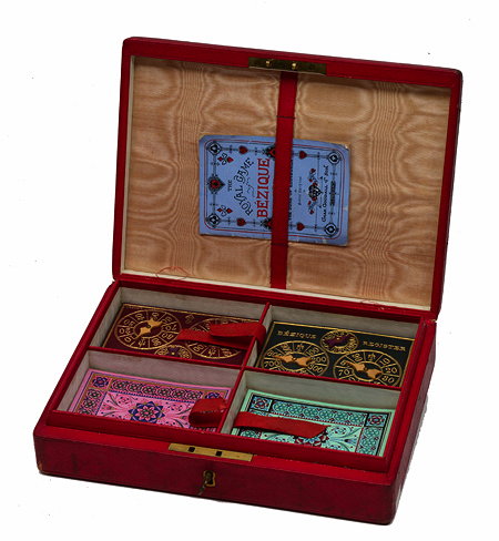 Appraisal: AN EDWARDIAN BEZIQUE GAME BOX containing four sets of playing