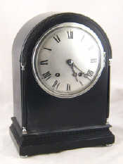 Appraisal: A handsome ebonised mantel clock with domed case silvered dial