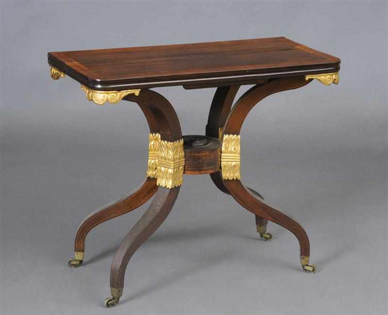 Appraisal: REGENCY INLAID ROSEWOOD AND PARCEL-GILT GAMES TABLE The line-inlaid cross-banded