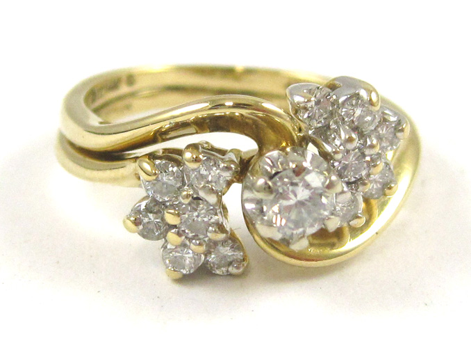 Appraisal: DIAMOND AND FOURTEEN KARAT GOLD LOVE STORY RING centering a