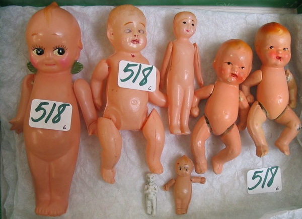 Appraisal: A GROUPING OF SIX CELLULOID AND CERAMIC BABY DOLLS including