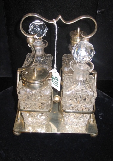 Appraisal: A ENGLISH FOUR-BOTTLE SILVERPLATED CONDIMENT SET holding cut crystal bottles