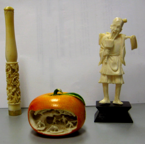 Appraisal: THREE CHINESE CARVED IVORY DECORATIONS Cigarette holder l deeply carved