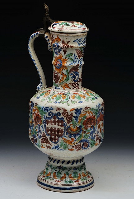 Appraisal: A CONTINENTAL FAIENCE POTTERY EWER with pewter mounts and hinged