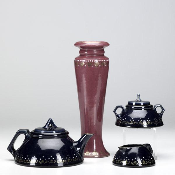 Appraisal: ROSEVILLE Aztec red vase and blue tea set with squeezebag