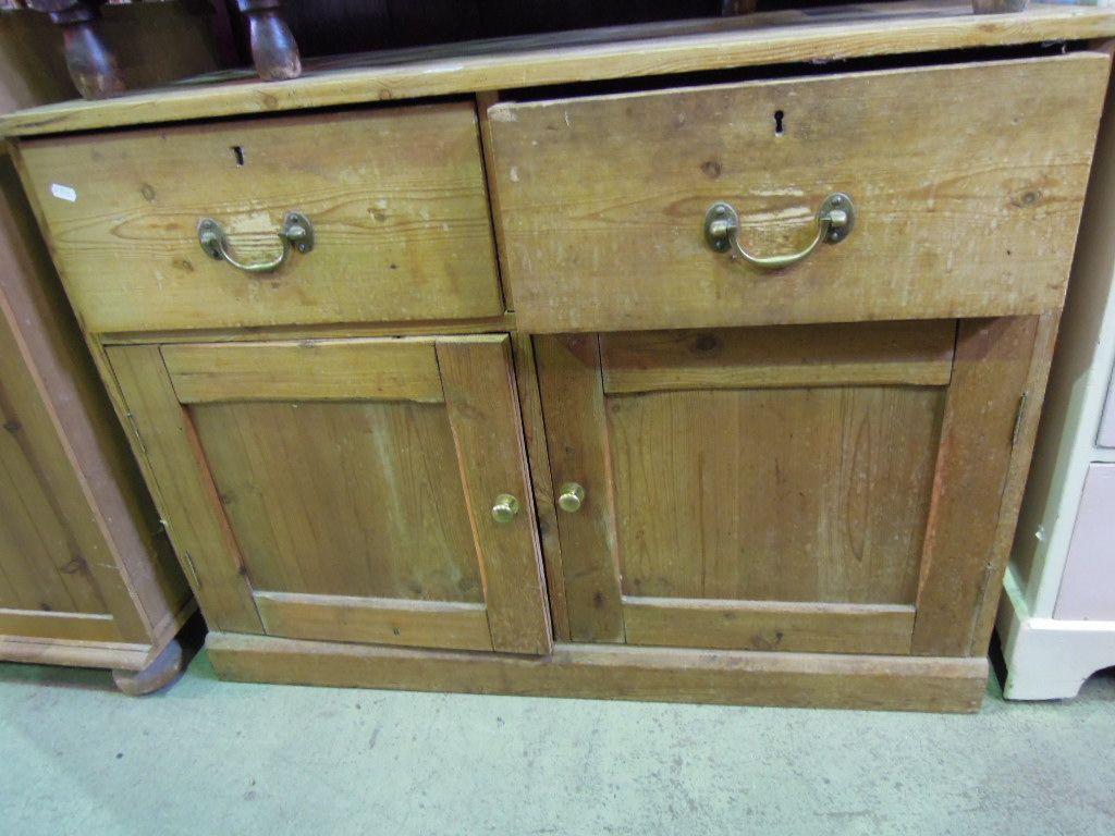 Appraisal: A stripped pine side cupboard enclosed by a pair of