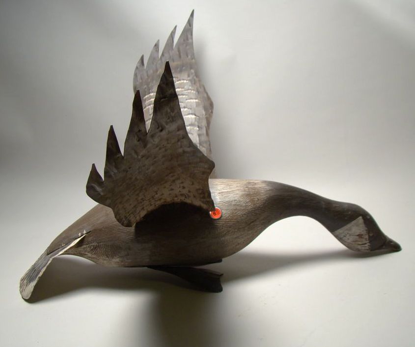 Appraisal: CONTEMPORARY CARVED CANADA GOOSE In flying form with tin wings