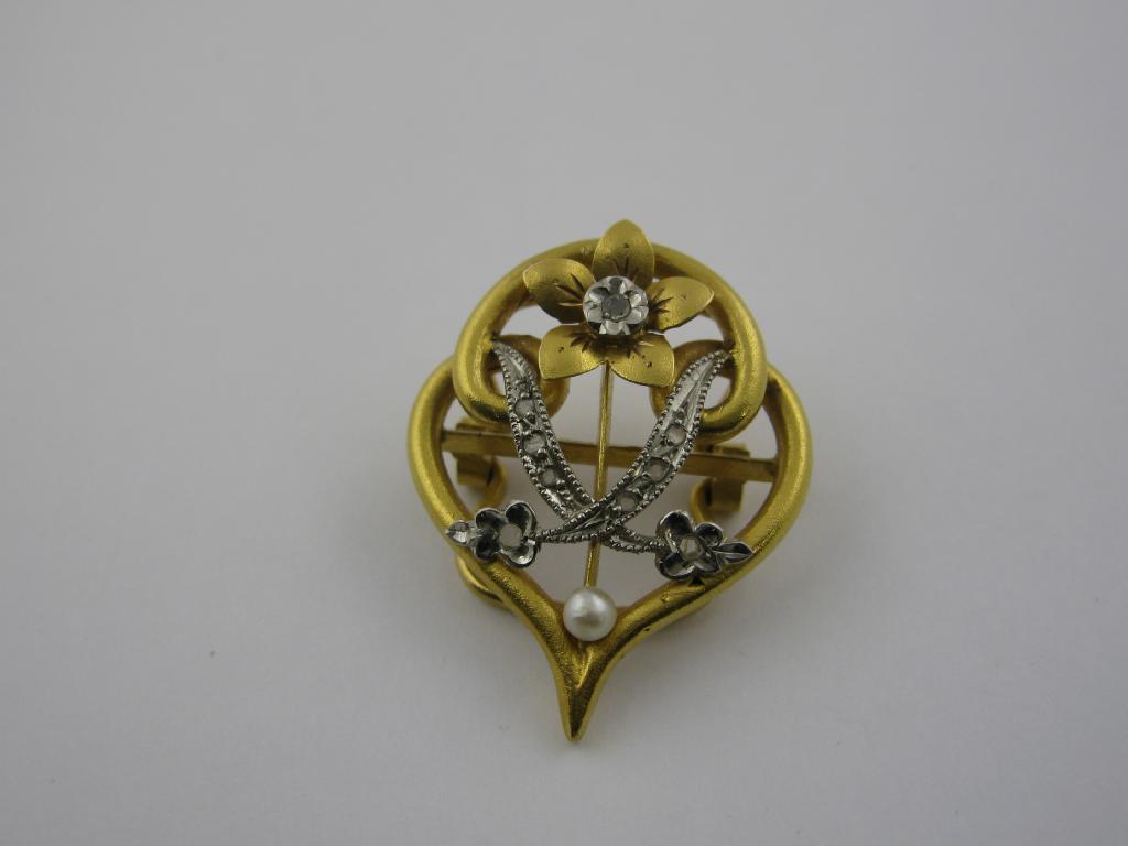 Appraisal: A Diamond and Seed Pearl Clip the openwork two coloured