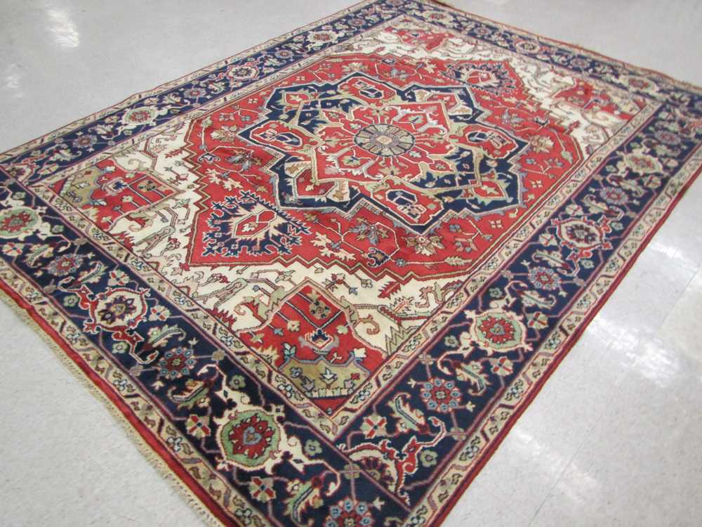 Appraisal: HAND KNOTTED ORIENTAL CARPET Indo-Heriz central geometric medallion and stylized