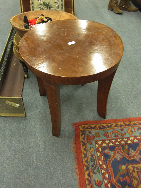 Appraisal: AN ART DECO CARVED POSSIBLY WALNUT CIRCULAR TABLE with four