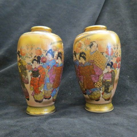 Appraisal: Pair of Satsuma Pottery Vases villagers elaborate gold work excellent