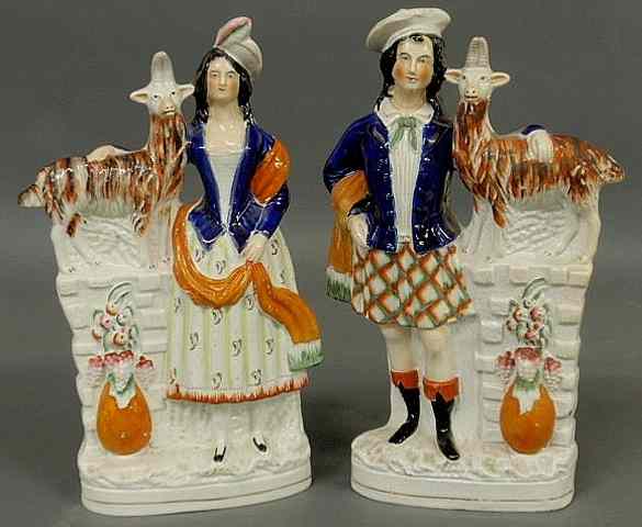 Appraisal: Pair of colorful th c Staffordshire figural groups of a