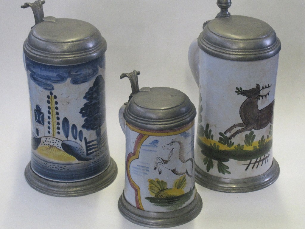 Appraisal: Three tin glazed pottery steins with pewter mounts and lids