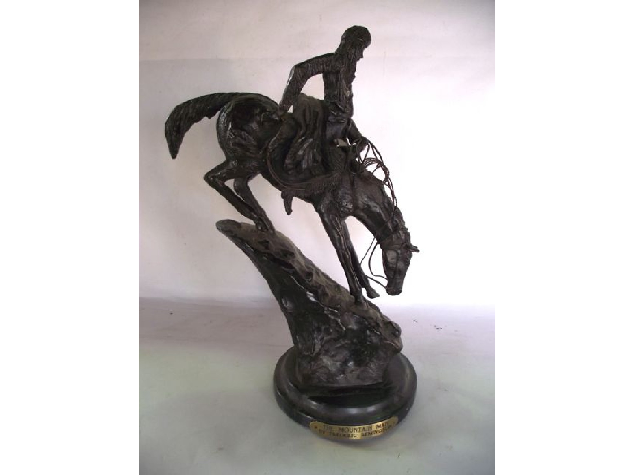 Appraisal: A cast bronze study of a native American and mount