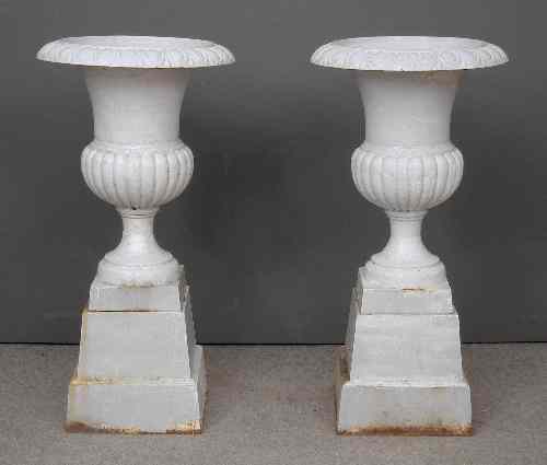 Appraisal: A pair of white painted cast iron garden urns of