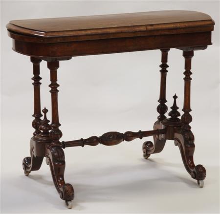 Appraisal: A Victorian walnut card table the moulded rectangular top over