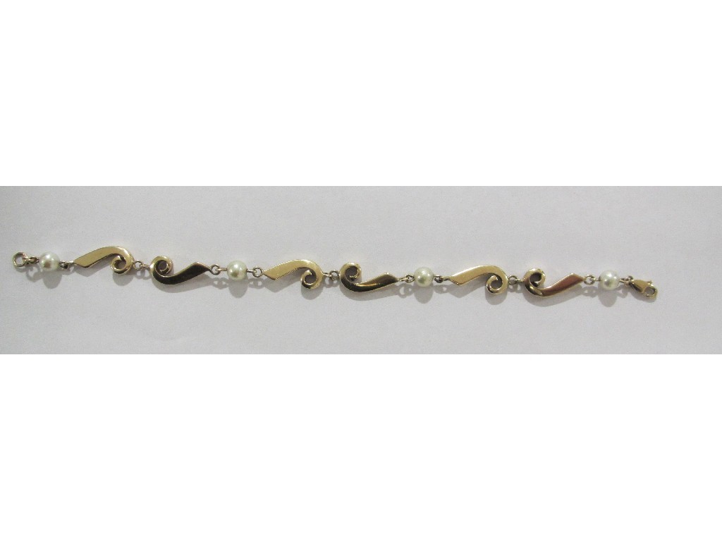 Appraisal: Nine carat gold cultured pearl spacer bracelet with scroll sections