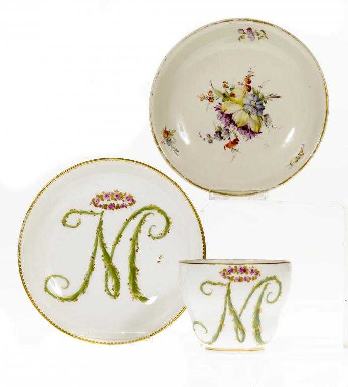 Appraisal: A MEISSEN TEA CUP AND SAUCER with entwined handle enamelled