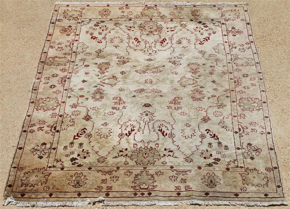 Appraisal: OUSHAK WOOL RUG cream field with dark red design approx