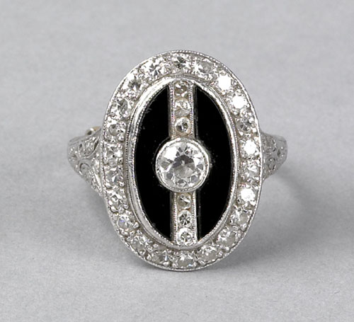 Appraisal: Diamond and onyx platinum ring with central ct round brilliant